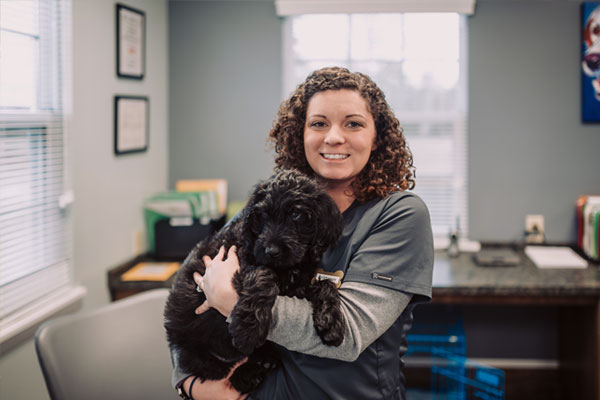 Girl holding dog